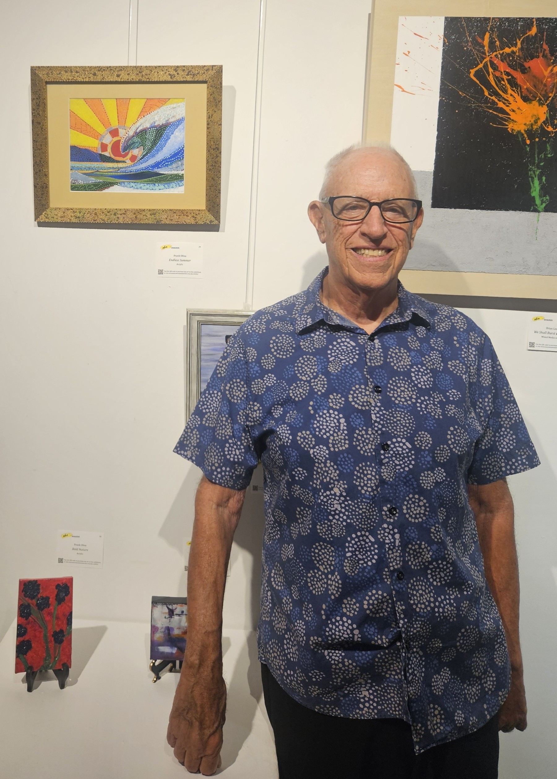 frank in a blue shirt in front of his art